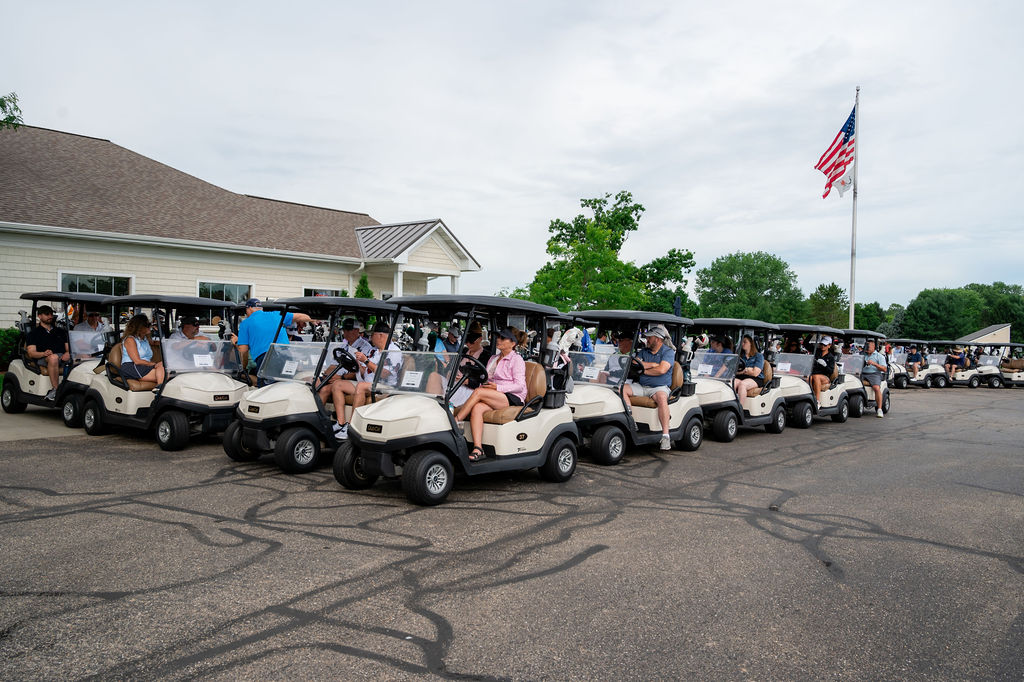 Golf carts lined up at Drive for Dreams charity golf outing supporting MCC special needs families